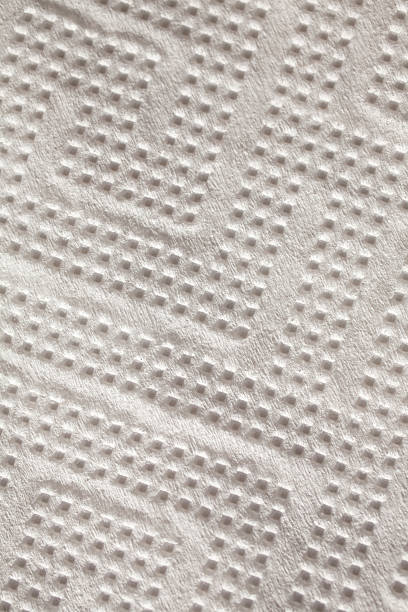 istock white perforated paper closeup background 526636379