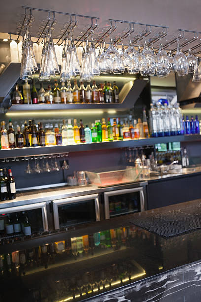 istock Close up on bar with wine glasses hanging above it 526638109