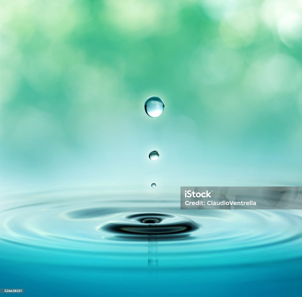 natural wellbeing concept close up of three droplets in a blurred green background Water Stock Photo