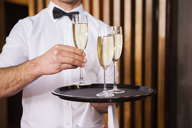 istock Waiter holding tray of champagne 526638511