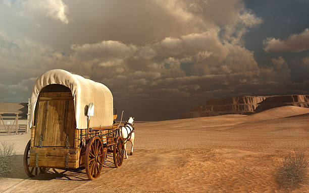 Old wagon in the desert Desert landscape with old wagon and rocks covered wagon stock pictures, royalty-free photos & images