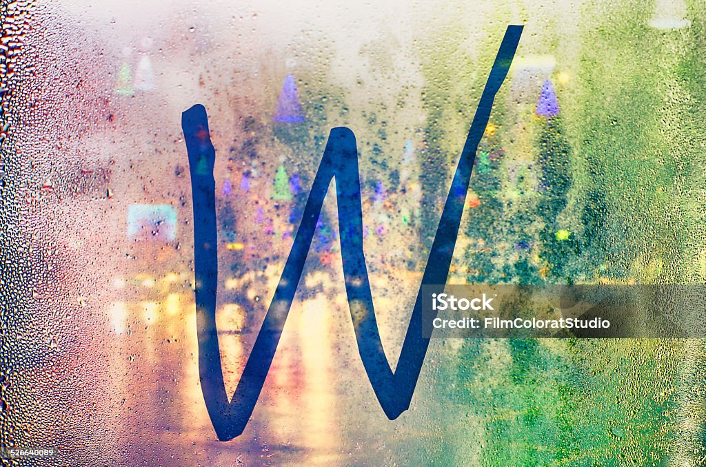 Isolated W letter. Isolated W letter. City atmosphere with drops texture in the background. Urban scene in Bucharest, Romania. Abstract Stock Photo