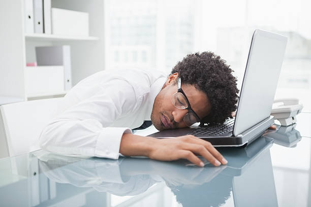 istock Businessman with glasses sleeping on laptop 526641183