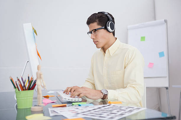 istock Serious designer listening music and working 526641363