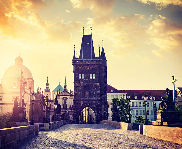 Charles bridge tower in Prague on sunrise Vintage retro hipster style travel image of Charles bridge tower in Prague on sunrise, Czech Republic old town bridge tower stock pictures, royalty-free photos & images