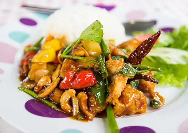 fried chicken stir fry with onion, cashew nut and sweet pepper eating with rice