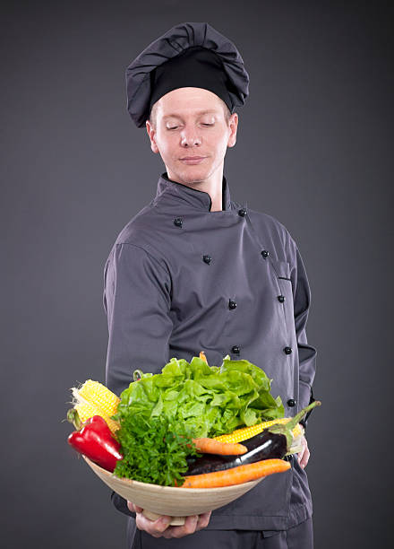 istock chef holding a basket of delicious fresh vegetables 526651589