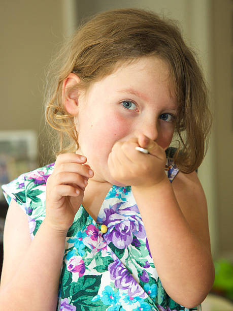 istock Young child eating jelly from a spoon 526651921