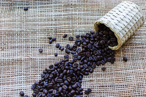 Coffee beans on Bamboo mat texture background