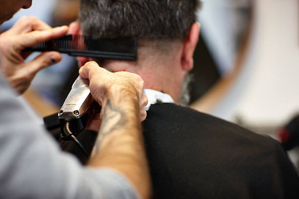 istock Man getting his hair trimmed with electric trimmer 526653051