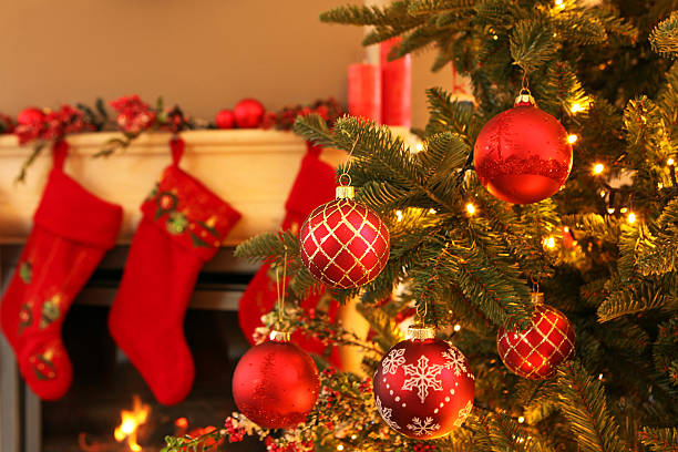 istock Christmas Balls Hanging on a Christmas Tree and Decorated Fireplace 526653737