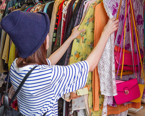 istock Asian woman looking at bags on rack 526653963