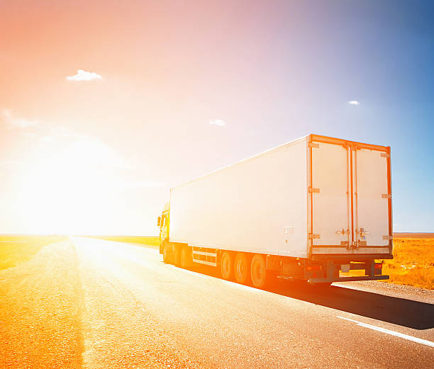 istock truck driving to sunset 526654491