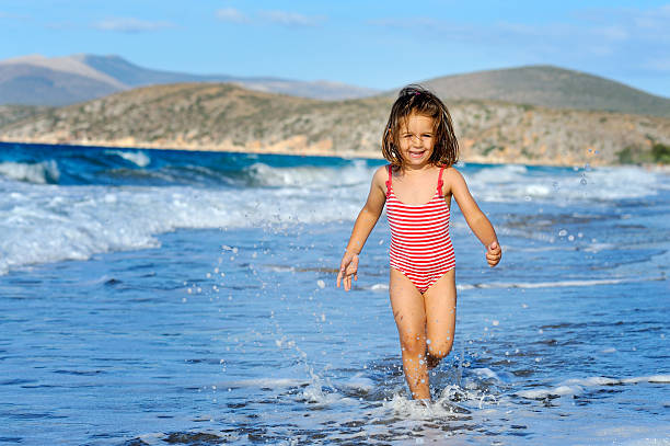Smiling toddler girl at beach