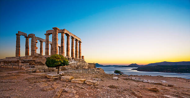 Temple of Poseidon at Cape Sounion, Greece Greece. Cape Sounion - Ruins of an ancient Greek temple of Poseidon after sunset ancient greece stock pictures, royalty-free photos & images