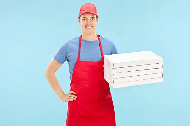 Photo of Pizza chef holding a bunch of boxes