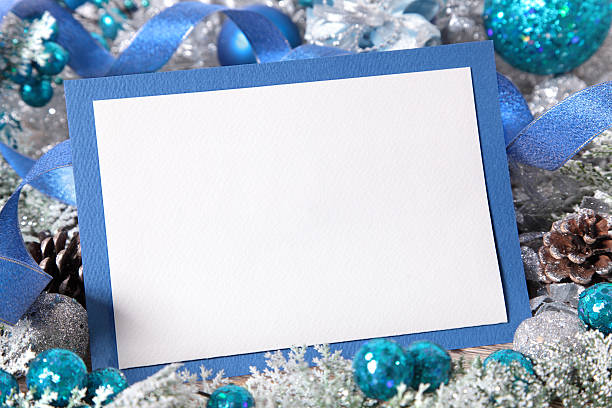 istock Christmas card or invitation with blue envelope surrounded by decorations 526657207