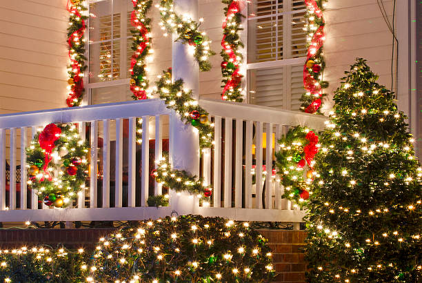 Home Decorated for the Holidays Close up detail of a Victorian-style home in a Christmas town/village that is beautifully decorated for the Holiday Season with lights, ornaments, wreaths and garlands. christmas lights house stock pictures, royalty-free photos & images