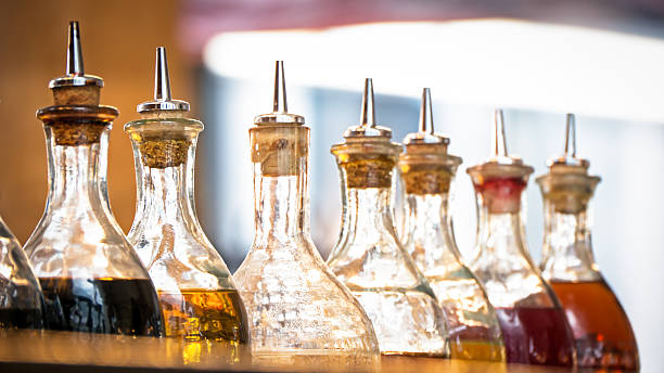 oil bottles bottles with oil at a restaurant in italy (near rome) vinegar bottle stock pictures, royalty-free photos & images