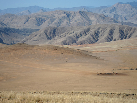 A distant view of a remote Himba tribe camp near the Skeleton Coast, Northern Namibia. 