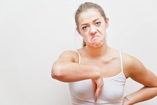 young woman doing an Italian hand gesture meaning she hates you
