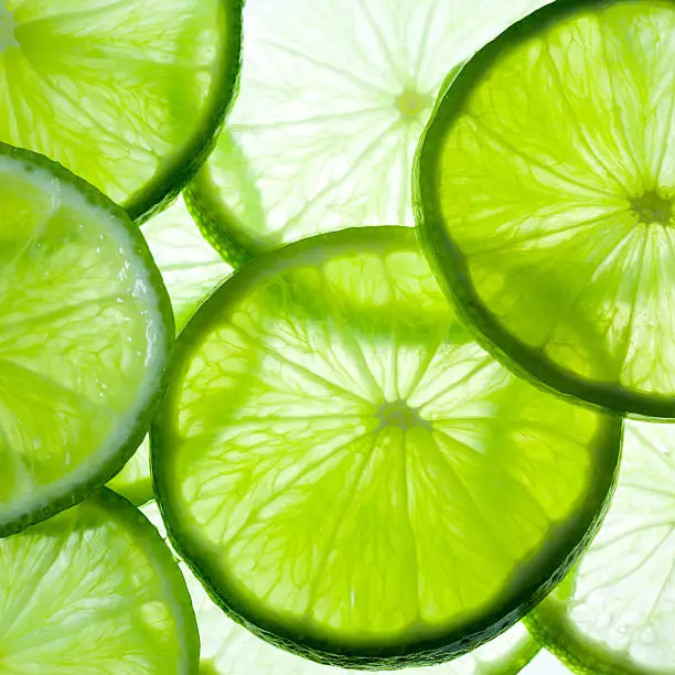 Green background with citrus-fruit of lime slices