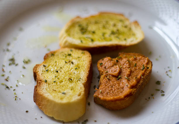 Bruschetta with oil and oregano on a white plate. Shot in Italy.