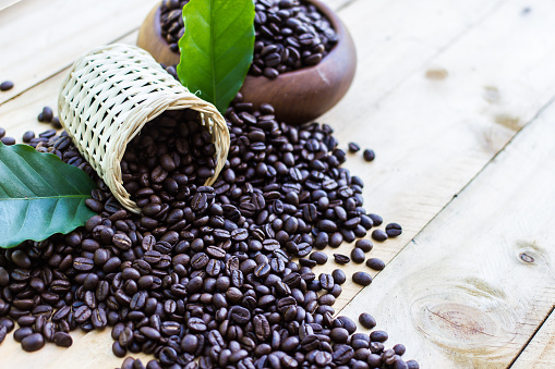 Coffee beans on wood texture background
