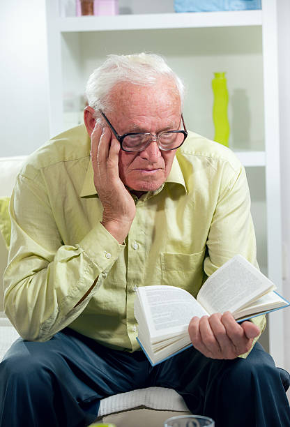 istock Senior Man Relaxing At Home Reading Book 526665495