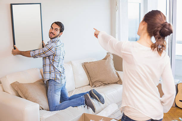 istock Cute couple hanging up a frame 526666637