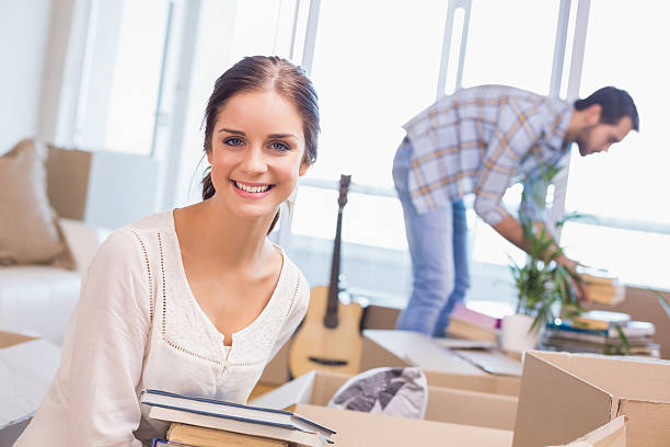 istock Cute couple unpacking cardboard boxes 526666651
