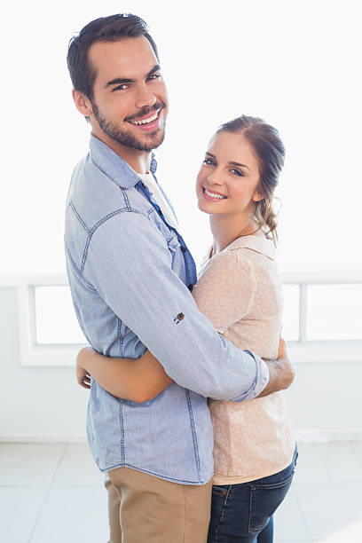 istock Cute couple hugging and smiling 526667107