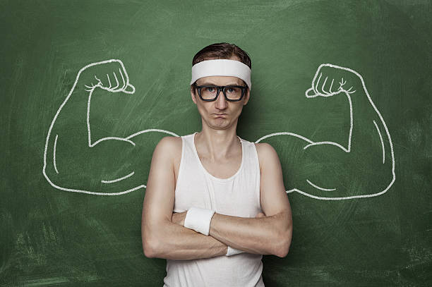 Funny sport nerd Funny sports nerd flexing fake muscle drawn on the chalkboard masculinity photos stock pictures, royalty-free photos & images