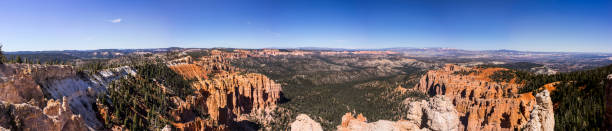 USA, State of Utah. Kane County. Bryce Canyon National Park. Overlook from Rainbow Point. Bryce Canyon National Park is a collection of natural amphitheaters along the eastern side of the Paunsaugunt Plateau. Its rim at varies from 8,000 to 9,000 feet. The Bryce Amphitheater is 12 miles long, 3 miles wide and 800 feet deep. The Paiute Indians believed that the hoodoos (pinnacles) were people whom the gods turned to stone. The area was named after Ebenezer Bryce, who was sent here by the Church of Jesus Christ of Latter-day Saints. He settled in this area in 1874. He pastured his cattle here, and said that these amphitheaters were a \
