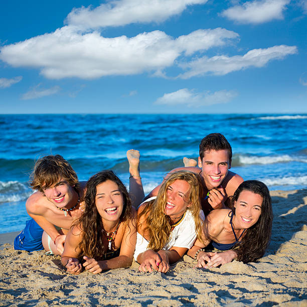 istock Boys and girls group having fun on the beach 526669947