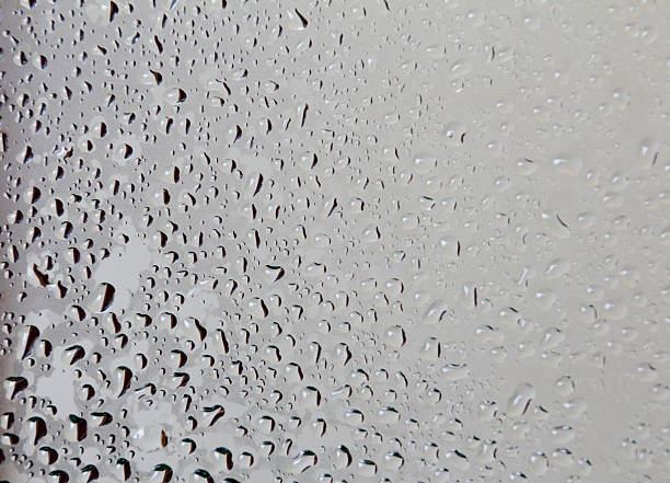 istock Water droplets on glass in dark to light colors 526682757
