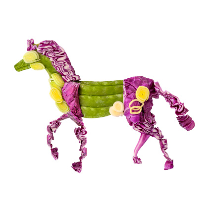 A food concept of a Chinese zodiac horse made of fruits and vegs isolated on white.
