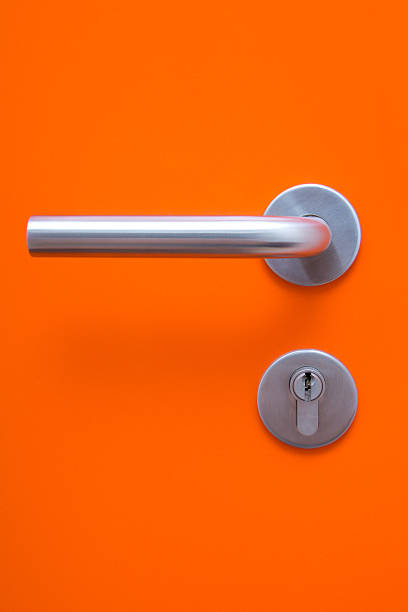 the part of orange door with metal handle - deurknop stockfoto's en -beelden