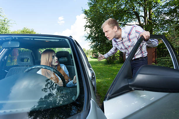 istock Man annoyed with female driver 526684429