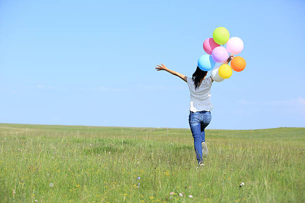 istock young asian woman  with colored balloons 526684687