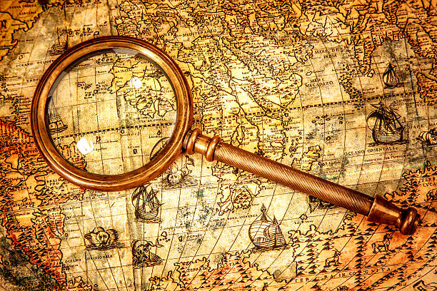 istock Vintage magnifying glass lies on an ancient world map 526686525