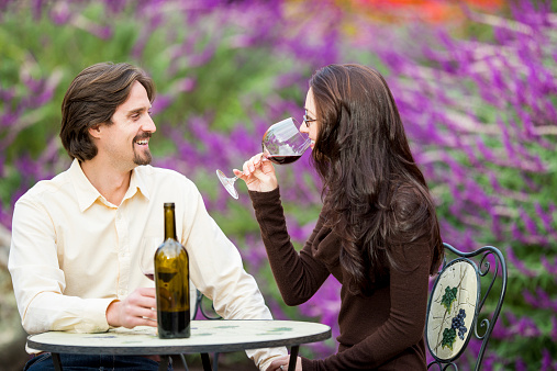 Young couple drinking wine outdoors
