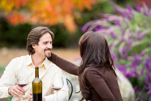 Young couple drinking wine outdoors