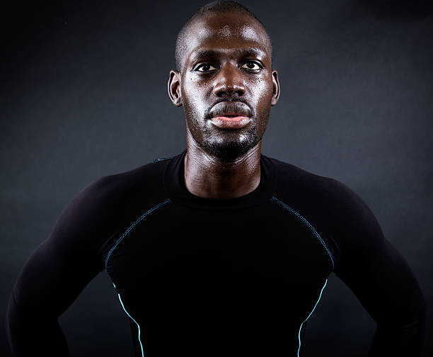 istock Athletic man running in black background. 526688127