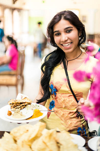 istock Indian female student in restaurant buffet 526688251