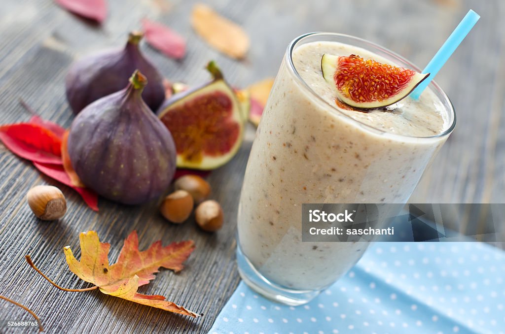 Healthy exotic smoothie variation with figs and nuts Fresh tasty beverage in autumn wooden background Autumn Stock Photo