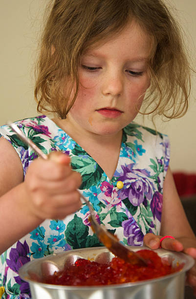 Young child making jelly/gelatine