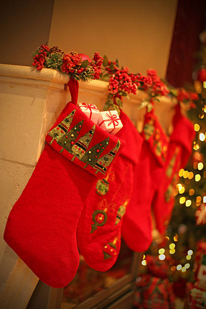 istock Red Christmas Stockings with Presents on a Mantelpiece 526703033