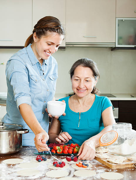 istock Family cooking sweet berries dumplings 526704099