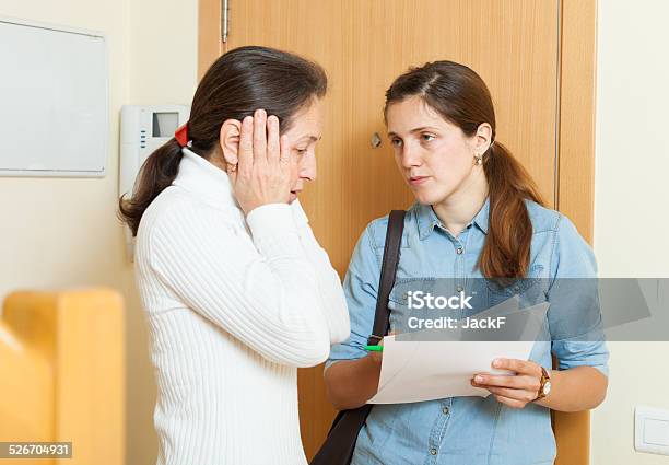 Businesswoman Trying To Collect Arrearages From Woman Stock Photo - Download Image Now